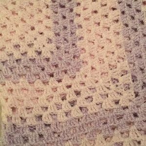 Light pink and purple hand knitted blanket